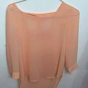 Peach colored blouse.